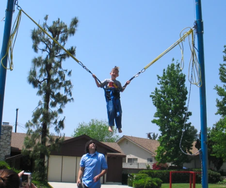 A person jumping high on a Euro Bungee trampoline, representing high-energy interactive attractions.