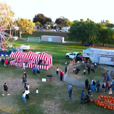 A group of guests wearing fun masks and props while posing inside a party photo booth rental.